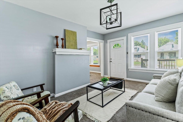 364 Clarendon Ave, Columbus, OH 43223 - carpeted living room featuring a chandelier and plenty of natural light