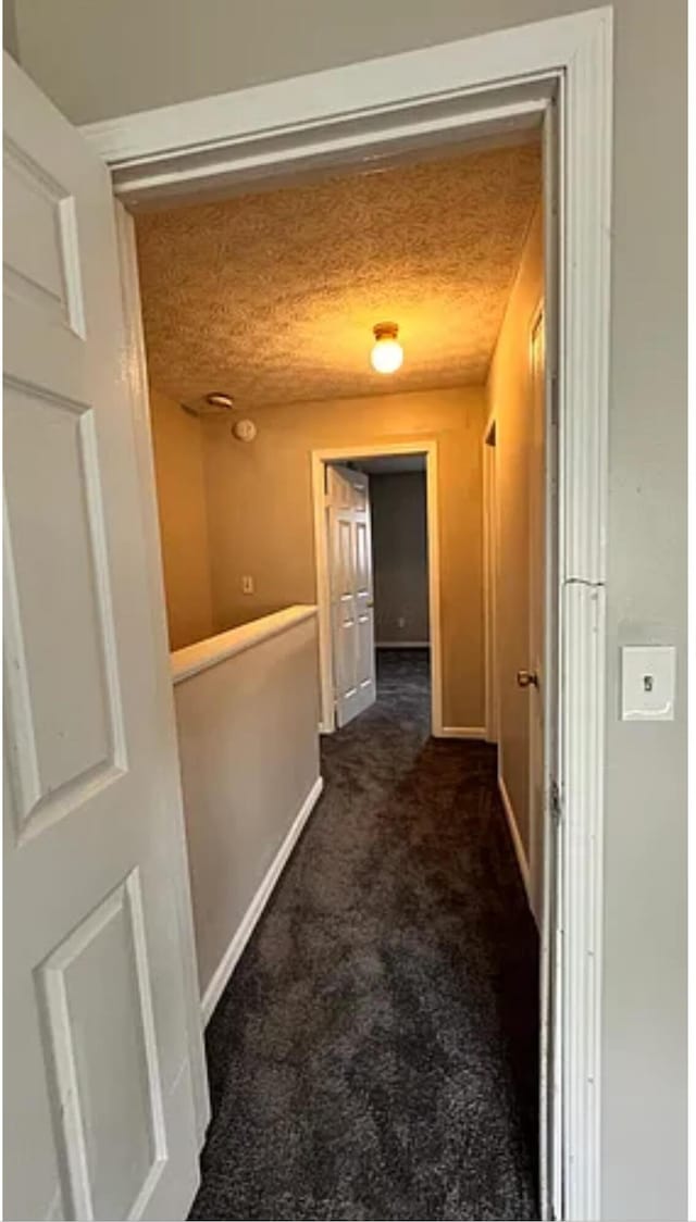 991 Hidden Acres Ct, Columbus, OH 43224 - hall featuring dark carpet and baseboards