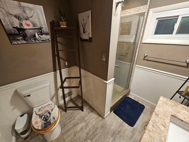 45 Shady Ln Unit 552On, Waverly, OH 45690 - bathroom featuring a shower stall, wainscoting, wood finished floors, vanity, and a decorative wall