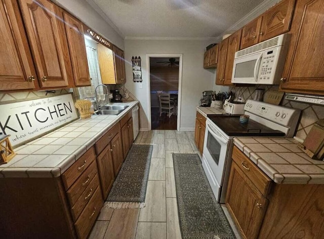 45 Shady Ln Unit 552On, Waverly, OH 45690 - kitchen featuring white appliances, tile countertops, backsplash, ceiling fan, and crown molding