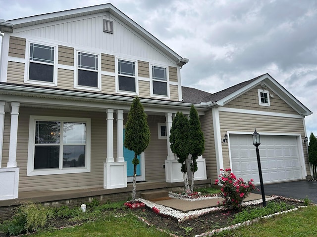 1021 Taylor Glen Blvd E, Pataskala, OH 43062 - view of front facade with covered porch, asphalt driveway, and a garage