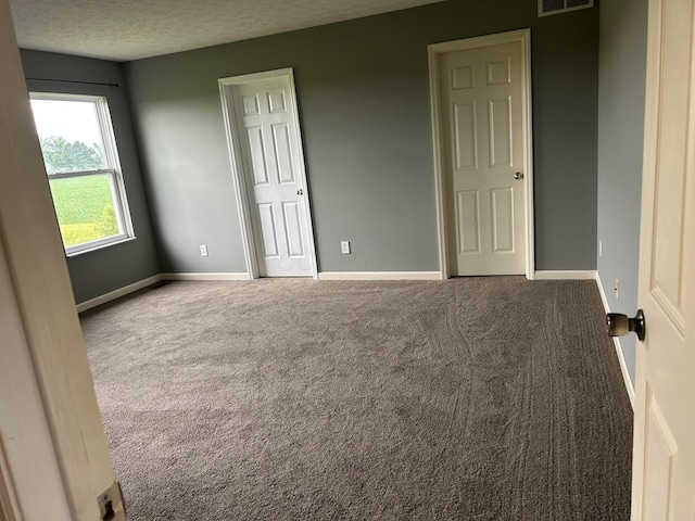 1021 Taylor Glen Blvd E, Pataskala, OH 43062 - unfurnished bedroom featuring carpet flooring and a textured ceiling