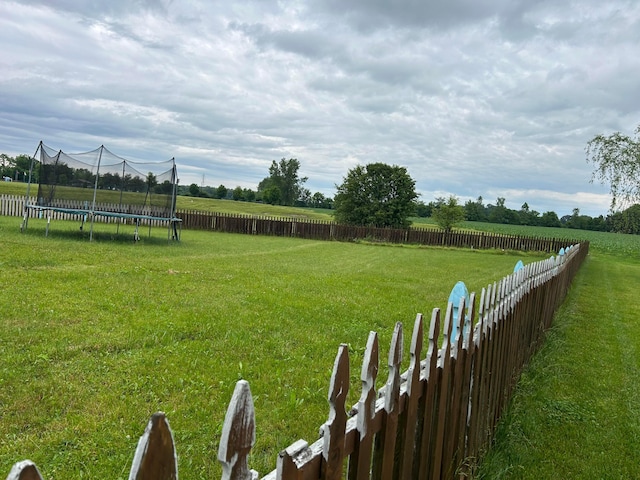 1021 Taylor Glen Blvd E, Pataskala, OH 43062 - fenced backyard featuring a trampoline and a view of countryside