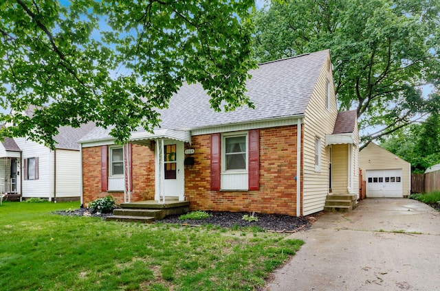 3064 Melva Ave, Columbus, OH 43224 - view of front facade with a shingled roof, brick siding, a front lawn, concrete driveway, and an outbuilding
