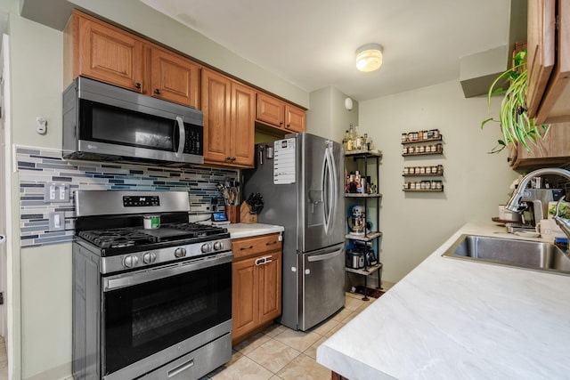 3064 Melva Ave, Columbus, OH 43224 - kitchen featuring stainless steel appliances, tasteful backsplash, light countertops, and light tile patterned flooring