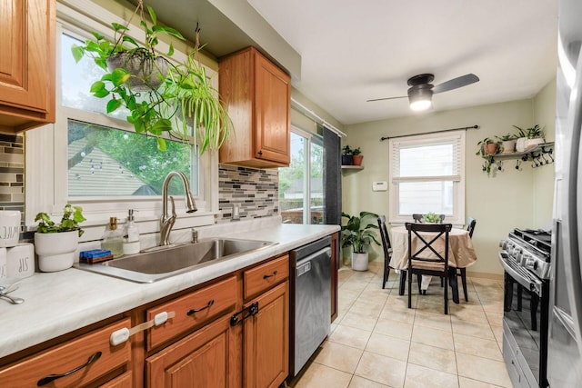 3064 Melva Ave, Columbus, OH 43224 - kitchen with appliances with stainless steel finishes, backsplash, a ceiling fan, light tile patterned floors, and brown cabinetry