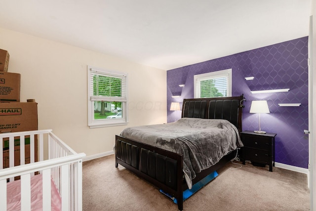 3064 Melva Ave, Columbus, OH 43224 - bedroom featuring multiple windows, carpet floors, an accent wall, and wallpapered walls