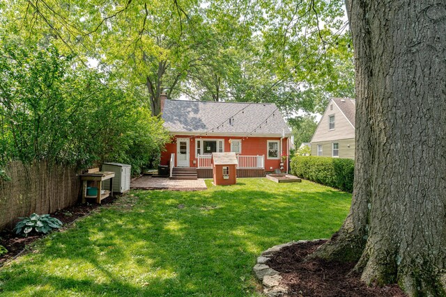 98 N Chesterfield Rd, Columbus, OH 43209 - rear view of property with a yard, a wooden deck, a chimney, and roof with shingles