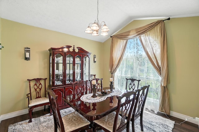 906 Linkfield Dr, Columbus, OH 43085 - dining area featuring a chandelier, vaulted ceiling, dark wood-style flooring, and a textured ceiling