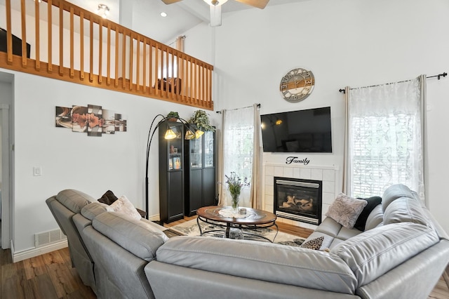 906 Linkfield Dr, Columbus, OH 43085 - living area with wood finished floors, ceiling fan, plenty of natural light, high vaulted ceiling, and a tiled fireplace
