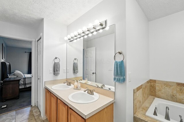 906 Linkfield Dr, Columbus, OH 43085 - full bath featuring a textured ceiling, double vanity, and a bath