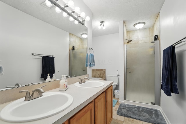 906 Linkfield Dr, Columbus, OH 43085 - full bathroom featuring a shower stall, a textured ceiling, double vanity, and tile patterned floors