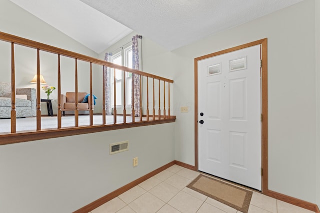 3550 Whisper Creek Dr, Columbus, OH 43231 - entrance foyer with light tile patterned flooring, vaulted ceiling, and a textured ceiling