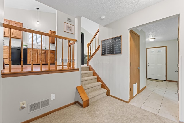 3550 Whisper Creek Dr, Columbus, OH 43231 - stairs with a textured ceiling, carpet floors, and tile patterned flooring