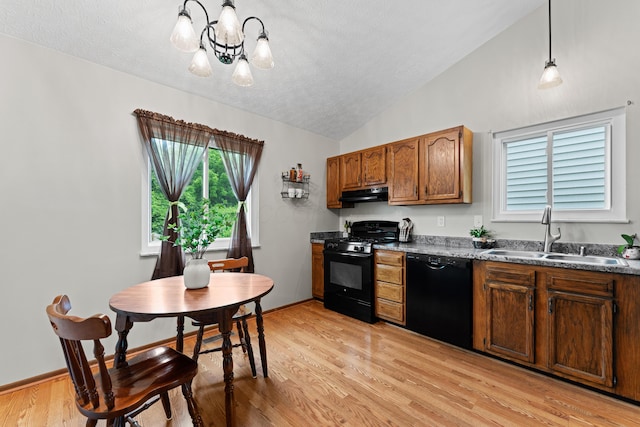 3550 Whisper Creek Dr, Columbus, OH 43231 - kitchen featuring black appliances, under cabinet range hood, a chandelier, vaulted ceiling, and light wood-style floors