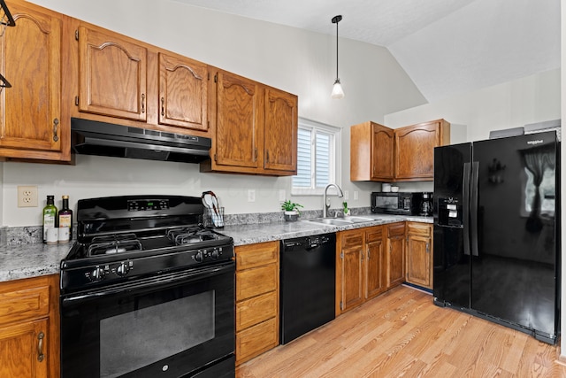 3550 Whisper Creek Dr, Columbus, OH 43231 - kitchen featuring black appliances, under cabinet range hood, light wood-style floors, brown cabinets, and lofted ceiling