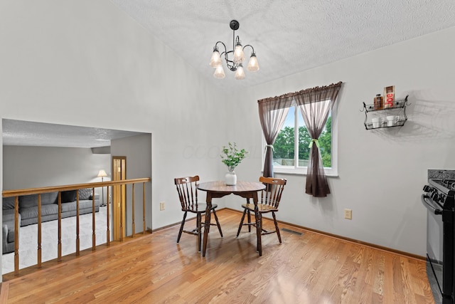 3550 Whisper Creek Dr, Columbus, OH 43231 - dining room featuring a textured ceiling, light wood-style flooring, and a chandelier