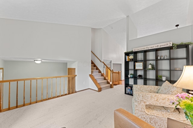 3550 Whisper Creek Dr, Columbus, OH 43231 - living area with carpet flooring, vaulted ceiling, and stairway