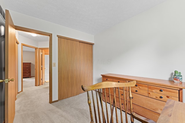 3550 Whisper Creek Dr, Columbus, OH 43231 - hall with light colored carpet, a textured ceiling, and an upstairs landing