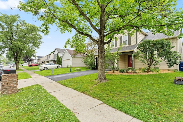 3550 Whisper Creek Dr, Columbus, OH 43231 - view of front facade featuring driveway, a front yard, a residential view, a shingled roof, and a garage