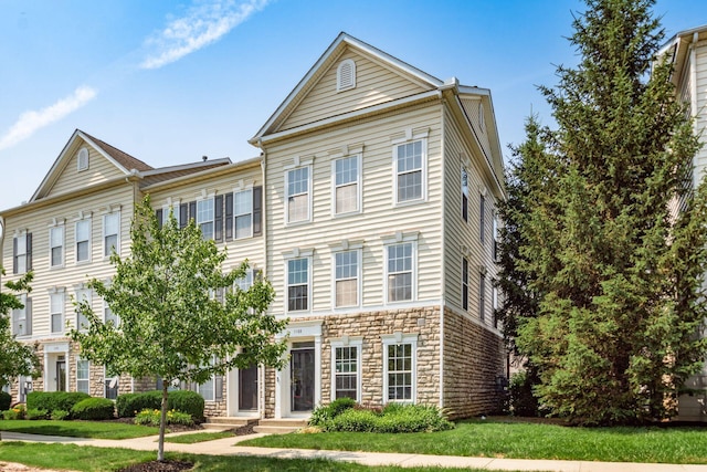 5588 Bow Falls Blvd Unit 35-558, Dublin, OH 43016 - view of front of home featuring stone siding and a front yard