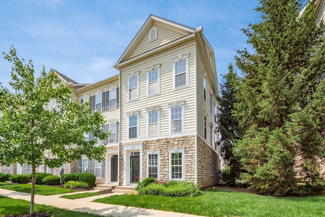 5588 Bow Falls Blvd Unit 35-558, Dublin, OH 43016 - view of front of house with stone siding and a front lawn
