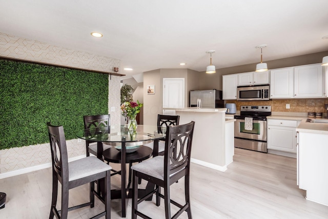 5588 Bow Falls Blvd Unit 35-558, Dublin, OH 43016 - dining room featuring light wood-type flooring and recessed lighting