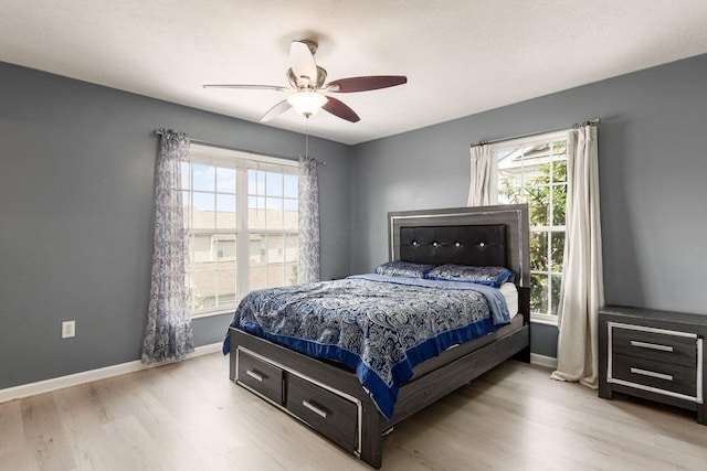 5588 Bow Falls Blvd Unit 35-558, Dublin, OH 43016 - bedroom with multiple windows, wood finished floors, and ceiling fan