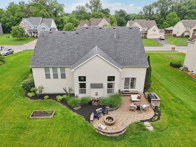 13946 Bainwick Dr NW, Pickerington, OH 43147 - rear view of property with an outdoor living space with a fire pit, a patio area, roof with shingles, and a lawn