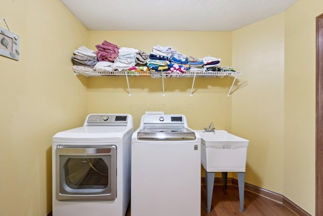 13946 Bainwick Dr NW, Pickerington, OH 43147 - washroom with washer and clothes dryer and wood finished floors