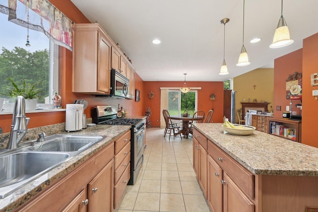 13946 Bainwick Dr NW, Pickerington, OH 43147 - kitchen featuring stainless steel appliances, a kitchen island, light tile patterned flooring, hanging light fixtures, and recessed lighting