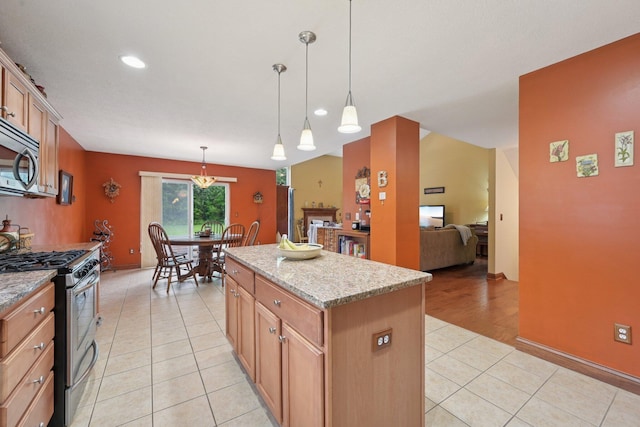 13946 Bainwick Dr NW, Pickerington, OH 43147 - kitchen featuring stainless steel appliances, light tile patterned floors, a center island, hanging light fixtures, and light stone countertops