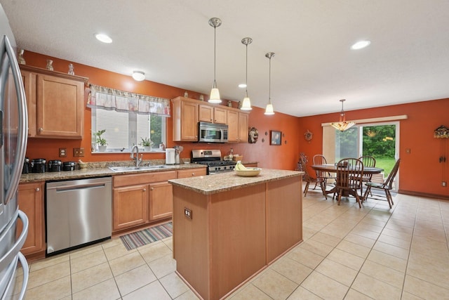 13946 Bainwick Dr NW, Pickerington, OH 43147 - kitchen featuring stainless steel appliances, a center island, healthy amount of natural light, light tile patterned floors, and recessed lighting