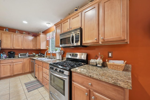 13946 Bainwick Dr NW, Pickerington, OH 43147 - kitchen with stainless steel appliances, light stone counters, light tile patterned floors, and recessed lighting