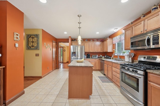 13946 Bainwick Dr NW, Pickerington, OH 43147 - kitchen with stainless steel appliances, a kitchen island, light tile patterned floors, recessed lighting, and decorative light fixtures