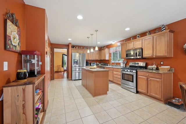 13946 Bainwick Dr NW, Pickerington, OH 43147 - kitchen featuring appliances with stainless steel finishes, a kitchen island, light tile patterned floors, recessed lighting, and decorative light fixtures