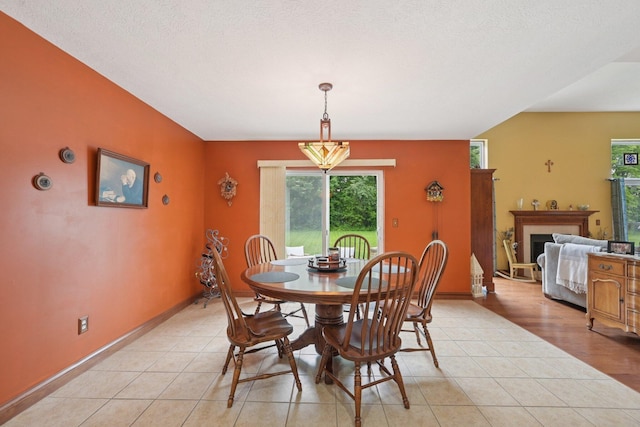 13946 Bainwick Dr NW, Pickerington, OH 43147 - dining area featuring plenty of natural light, light tile patterned floors, and a fireplace