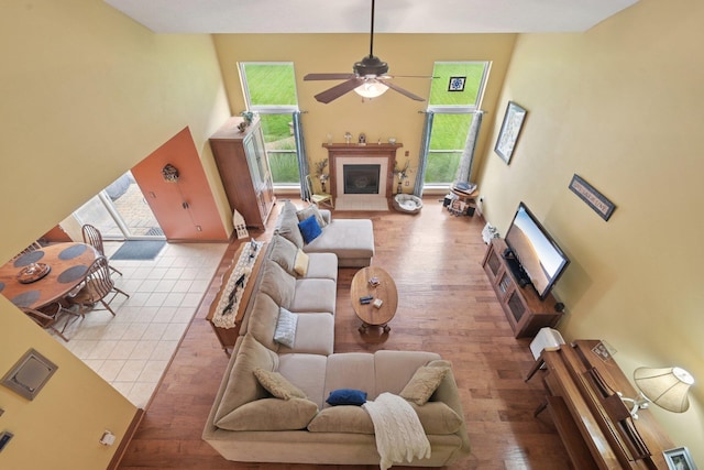 13946 Bainwick Dr NW, Pickerington, OH 43147 - living room with a ceiling fan, wood-type flooring, a fireplace, and a high ceiling
