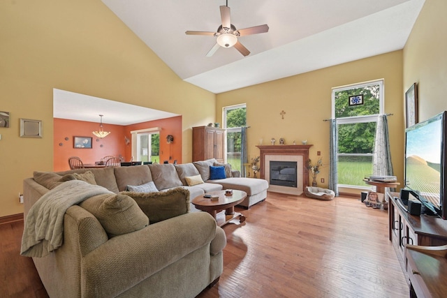 13946 Bainwick Dr NW, Pickerington, OH 43147 - living room featuring high vaulted ceiling, wood finished floors, a tiled fireplace, and ceiling fan