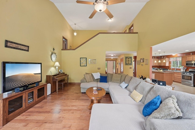 13946 Bainwick Dr NW, Pickerington, OH 43147 - living area featuring a towering ceiling, light wood finished floors, and ceiling fan