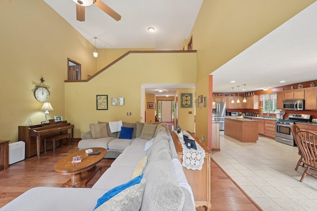 13946 Bainwick Dr NW, Pickerington, OH 43147 - living room with ceiling fan, high vaulted ceiling, and light wood-style floors