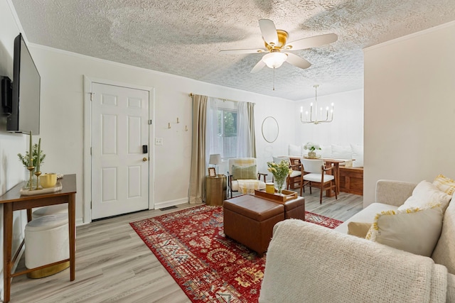 3029 Mcguffey Rd, Columbus, OH 43224 - living area featuring light wood-type flooring, a ceiling fan, a chandelier, a textured ceiling, and crown molding