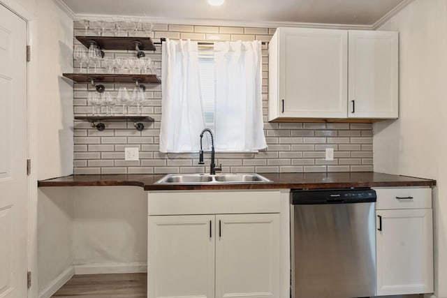 3029 Mcguffey Rd, Columbus, OH 43224 - kitchen with dishwasher, dark countertops, backsplash, white cabinets, and ornamental molding