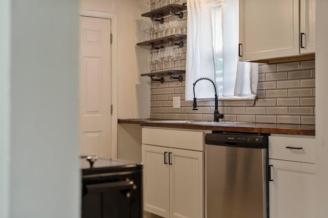 3029 Mcguffey Rd, Columbus, OH 43224 - kitchen with stainless steel dishwasher, backsplash, open shelves, white cabinetry, and butcher block countertops