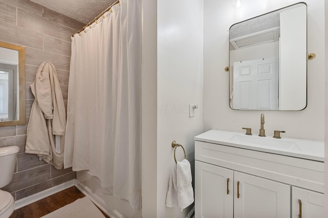 3029 Mcguffey Rd, Columbus, OH 43224 - bathroom featuring vanity, wood finished floors, tile walls, and shower / bath combo with shower curtain