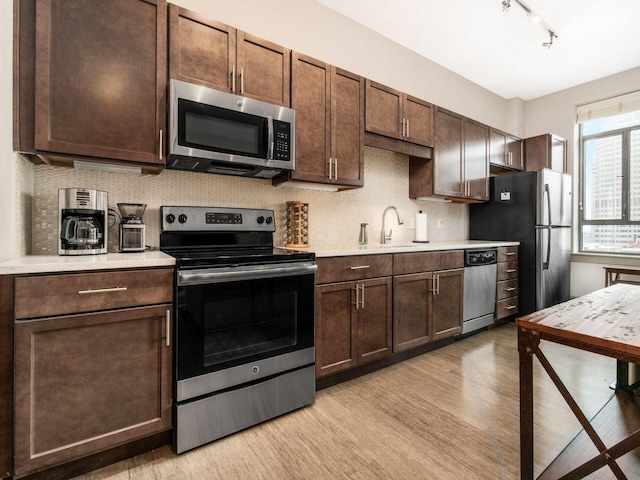 51 N High St Unit 804, Columbus, OH 43215 - kitchen featuring stainless steel appliances, light wood-type flooring, light countertops, and dark brown cabinetry