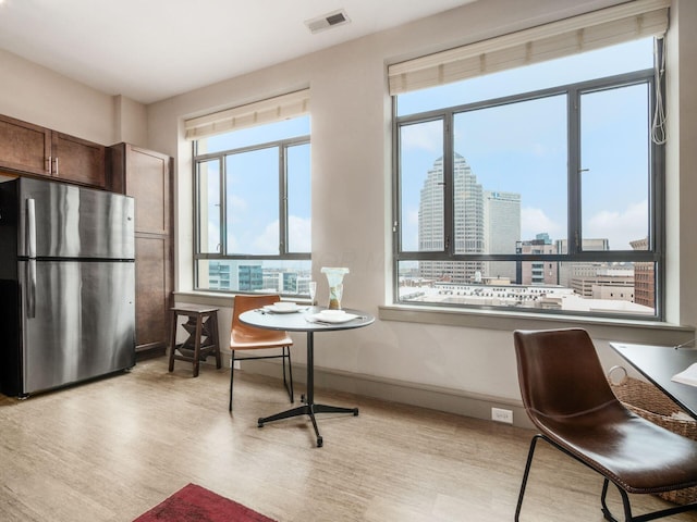 51 N High St Unit 804, Columbus, OH 43215 - dining area featuring light wood-style floors and a city view
