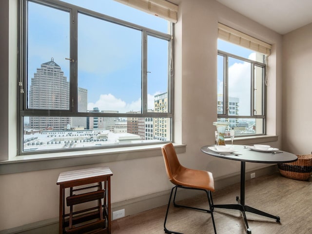 51 N High St Unit 804, Columbus, OH 43215 - dining space featuring wood finished floors, healthy amount of natural light, and a city view