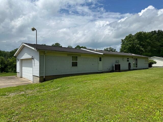 10830 Voris Rd, Logan, OH 43138 - rear view of house featuring a lawn and a detached garage