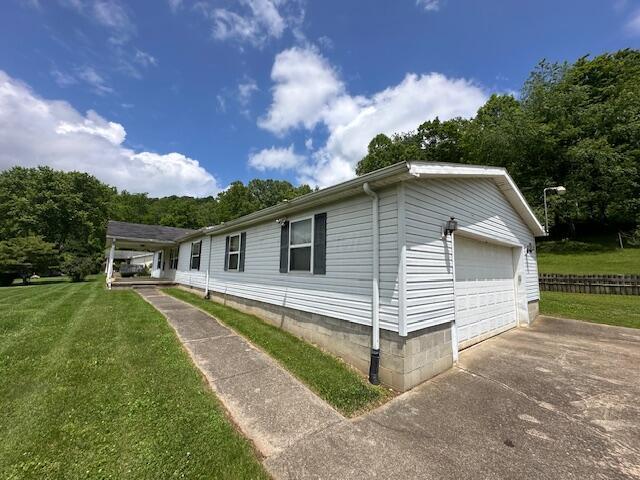 10830 Voris Rd, Logan, OH 43138 - view of home's exterior with a lawn and a detached garage